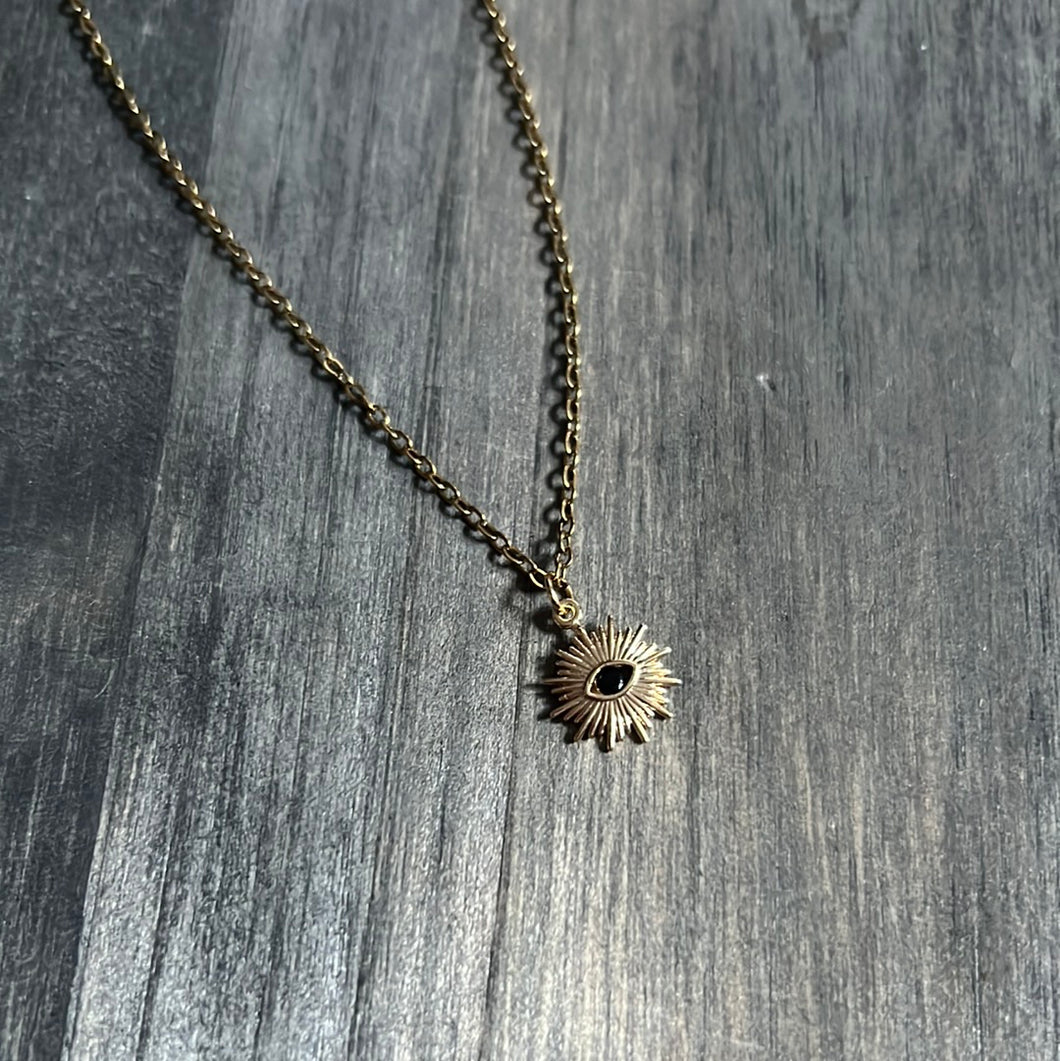 Gold plated sun and dark eye necklace